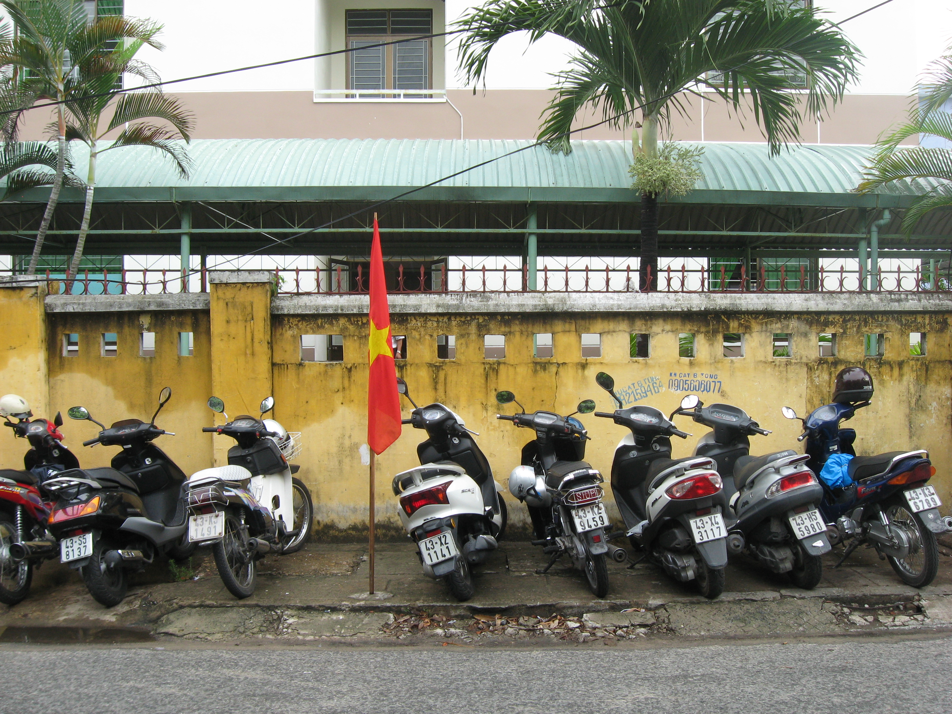 Motorbikes parked against a wall in Da Nang